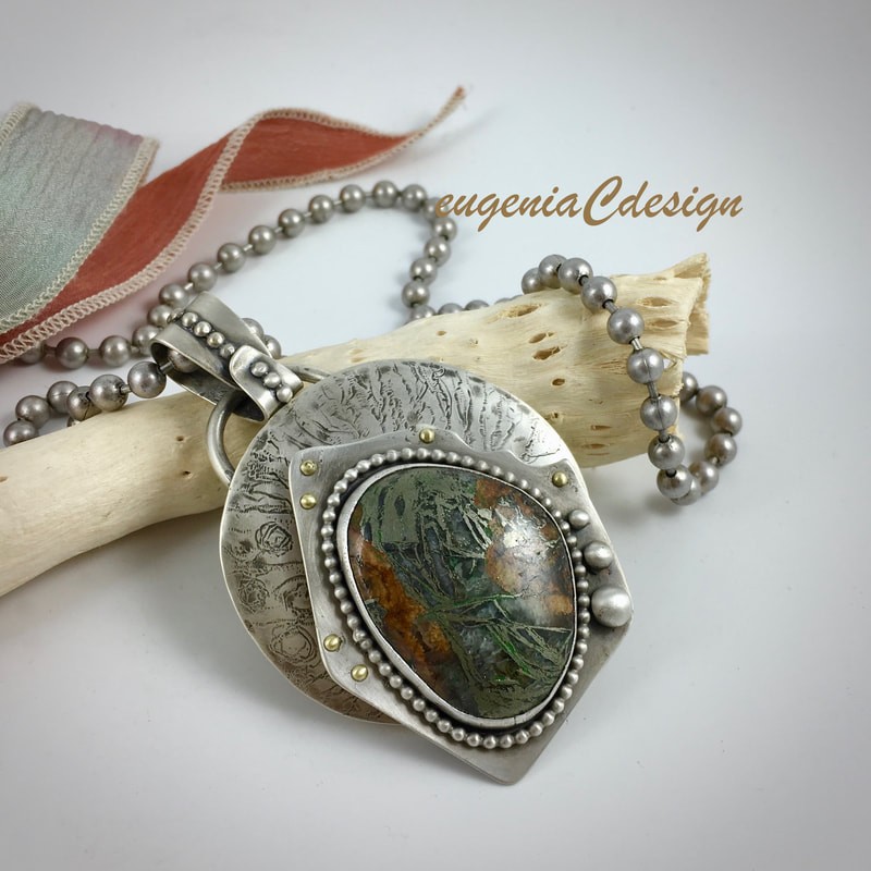 Handmade silver pendant set with a natural stone, by Eugenia Chan